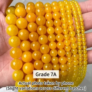 Close-up of translucent yellow agate beads in various sizes for DIY jewelry making