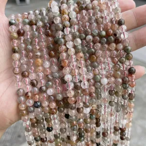 Close-up of 6mm natural rutilated quartz beads showing clear texture and inclusions.