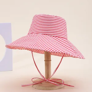 Red and white striped wide brim bucket hat for women, foldable sun protection beach hat.