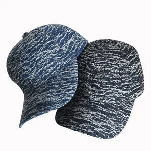 Detailed view of the vintage washed denim baseball cap showcasing abstract print texture.
