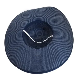 Detailed view of wide-brimmed navy blue straw sun hat with interior white elastic strap