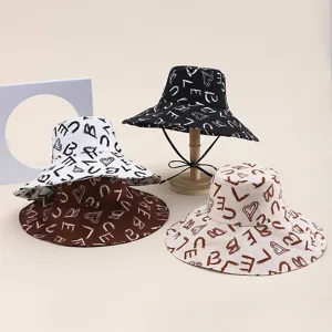 Stylish foldable wide-brim bucket hat with artistic letter print for summer beach sun protection.