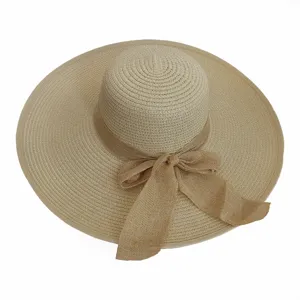 Elegant wide-brimmed straw sun hat featuring a decorative oversized linen bow detail