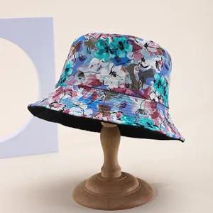 Detailed view of reversible sun hat with vibrant floral print pattern and black lining
