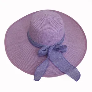 Top view of elegant purple wide brim straw sun hat featuring a decorative bowknot ribbon