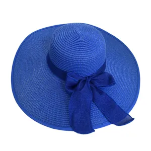 Royal blue wide-brimmed straw sun hat with matching mesh bow decoration for beach travel.