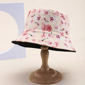Detailed view of a reversible bucket hat featuring a pink cherry blossom print