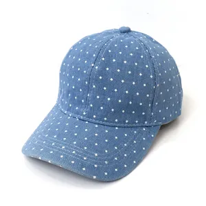 Detailed close-up shot of the blue denim baseball cap featuring white polka dots and texture.
