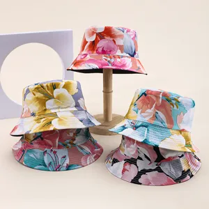 Detailed view of various floral print reversible bucket hats for summer sun protection.