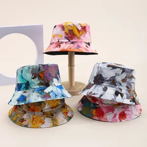 Selection of vibrant floral printed reversible bucket hats for summer sun protection.