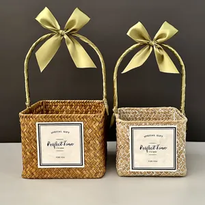 Handmade woven straw gift baskets with elegant satin bows in natural and white colors