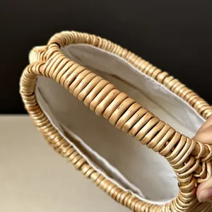 Detailed view of handmade woven rattan wicker bag texture, natural summer handbag craft.