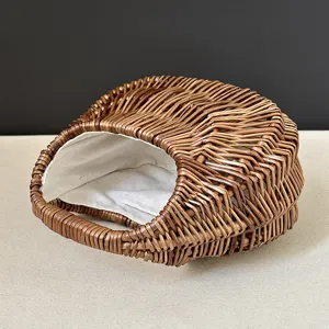 Close-up of the stylish woven rattan handbag, featuring a unique moon shape and soft lining.