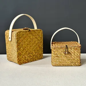 Handcrafted woven straw storage basket gift box with handle, natural rattan home organizer.