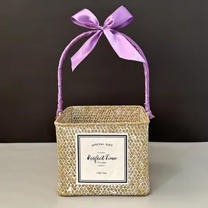 Macro view of woven square gift basket with purple ribbon handle and special gift label