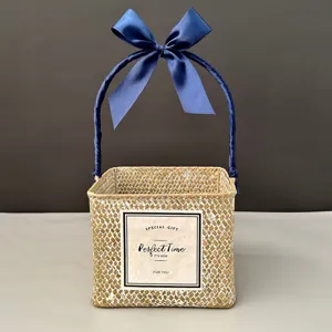 Detailed view of a handmade square woven gift basket featuring an elegant blue ribbon bow