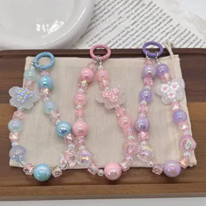 Macro view of colorful beaded phone charms with butterfly and flower pendants