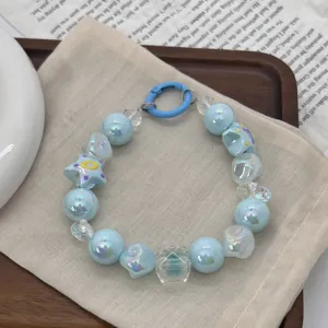 Close-up of hand-painted blue iridescent beads on a sweet dopamine phone strap