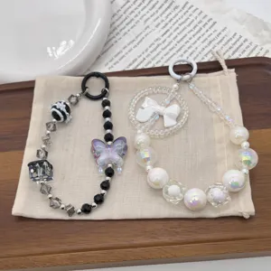 Macro view of handcrafted beaded charms with butterfly and bow on a linen pouch