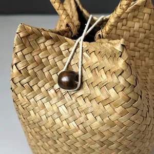 Close-up view showing the intricate texture of a handmade seagrass woven basket bag