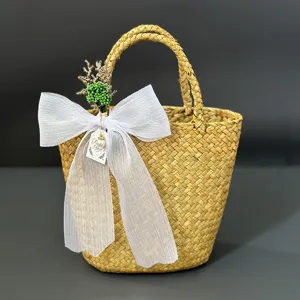 Handmade straw woven basket detail featuring elegant white organza bow and floral decor.