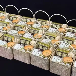 Woven gift basket with handles, ideal for wedding bridesmaid gifts and party packaging details.