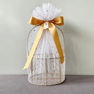 Golden wire gift basket with white star tulle and gold ribbon bow for weddings and parties.