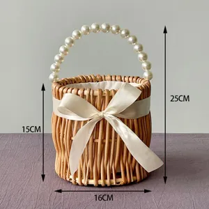 Detailed macro view of handmade wicker wedding basket with pearl handle and satin bow