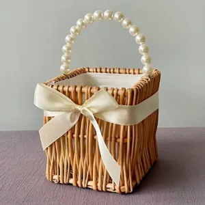 Detailed view of woven willow basket with elegant pearl handle and cream bow accent