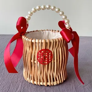 Detailed view of handmade woven rattan wedding gift basket with elegant pearl handle
