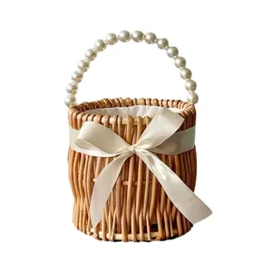 Exquisite round wicker wedding gift basket featuring elegant pearl handle and cream satin bow