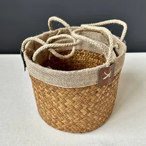 Natural seagrass woven storage basket detail with sturdy handles and nesting design for home decor.