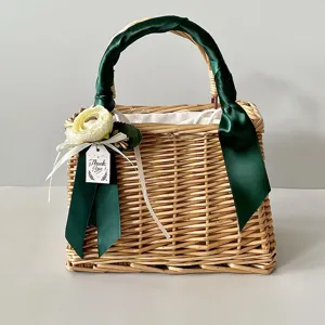 Handmade woven bamboo basket detail with dark green satin handle and flower