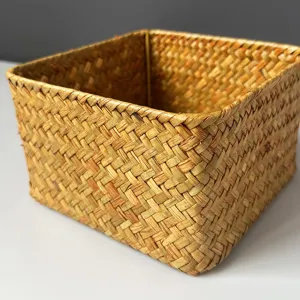 Handmade woven straw storage basket desktop organizer box for home debris and snack storage.