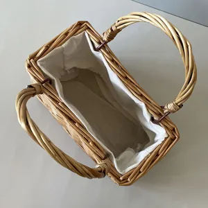 Top view of a handwoven bamboo gift basket featuring a soft white inner fabric lining