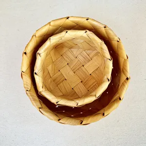 Detailed top-down view showing natural texture of nested Japanese style woven wooden baskets