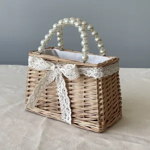 Detailed view of handmade wicker basket with elegant pearl handle and lace bow
