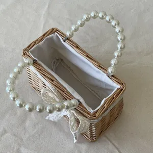 Detailed macro view of a vintage woven wicker gift basket featuring elegant pearl handles.