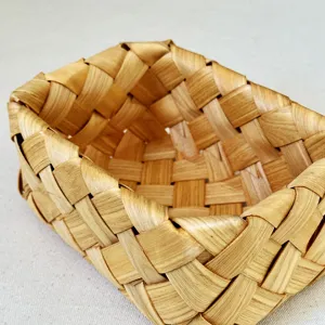 Detailed close-up of a hand-woven wooden basket showing natural grain texture and weave