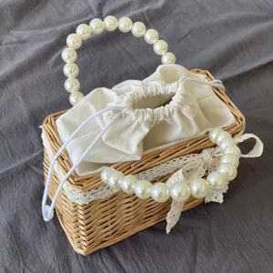 Close-up of elegant pearl handle and rustic wicker texture on a woven basket gift bag