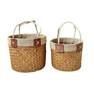 Handmade seagrass woven storage basket with jute trim and handles for home organization.