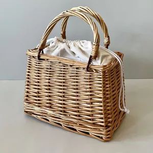 Handcrafted willow wicker gift basket with cream canvas drawstring liner and braided handles