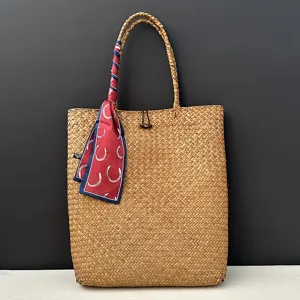 Handcrafted large straw woven tote bag for women summer beach travel with a chic scarf.