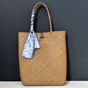 Large woven straw tote bag with blue floral scarf for summer beach vacation and daily use