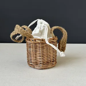 Small woven basket with canvas drawstring inner bag and jute handles for handmade gifts.