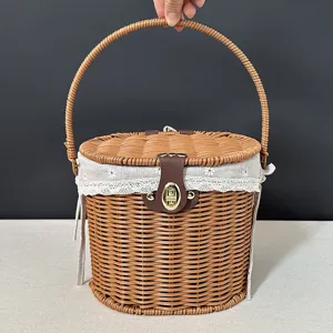 Handmade woven rattan picnic basket with lid and floral fabric lining for fruit and storage.