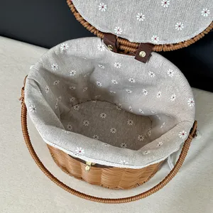 Woven rattan storage basket with lid, cute daisy print fabric lining and sturdy handle.