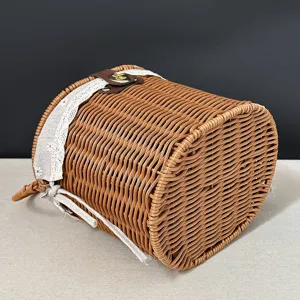 Woven storage basket detail view, imitation rattan picnic basket with lace trim and lock.