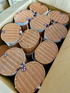 Woven imitation rattan storage basket with lid liner and handle for picnic and fruit organization.
