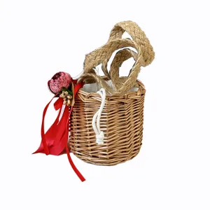 Cylindrical woven straw mini basket with red ribbon, ideal for wedding candy and favors.
